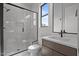 This bathroom has a glass enclosed shower, a white sink, and modern vanity at 200 Broadleaf Ln, Youngsville, NC 27596