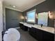 Luxury bathroom with double vanities, a soaking tub, and modern fixtures at 200 Broadleaf Ln, Youngsville, NC 27596