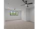 Open bedroom showcasing a large window with great scenery and modern ceiling fans at 200 Broadleaf Ln, Youngsville, NC 27596