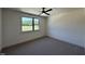 Bedroom with neutral paint, a ceiling fan, and a large window with trees visible outside at 200 Broadleaf Ln, Youngsville, NC 27596