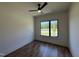 Bedroom featuring hardwood floors, a modern ceiling fan, and a large window with views at 200 Broadleaf Ln, Youngsville, NC 27596