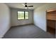 Bedroom with a ceiling fan, window with backyard view, and closet with shelving at 200 Broadleaf Ln, Youngsville, NC 27596