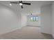Spacious open bedroom featuring modern ceiling fans and a large window at 200 Broadleaf Ln, Youngsville, NC 27596