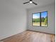 This bedroom features hardwood floors, a ceiling fan, and a large window at 200 Broadleaf Ln, Youngsville, NC 27596