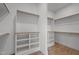 This walk-in closet offers ample storage with built-in shelving and hanging racks at 200 Broadleaf Ln, Youngsville, NC 27596