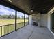 Covered porch with stone fireplace and ceiling fan overlooking a grassy yard at 200 Broadleaf Ln, Youngsville, NC 27596