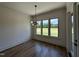 Bright dining room with modern lighting and a view of the lush outdoor landscape at 200 Broadleaf Ln, Youngsville, NC 27596