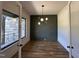 Dining room with hardwood floors and modern light fixture overlooking an outside stone facade at 200 Broadleaf Ln, Youngsville, NC 27596