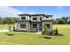 Beautiful two-story home with stone accents, manicured lawn, and professional landscaping at 200 Broadleaf Ln, Youngsville, NC 27596