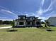 Beautiful two-story home with a well-manicured lawn and stone accents under a clear blue sky at 200 Broadleaf Ln, Youngsville, NC 27596