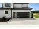 Home exterior shows garage with carriage door, side door, and landscaping at 200 Broadleaf Ln, Youngsville, NC 27596