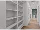 This hallway features hardwood floors and floor-to-ceiling built-in bookshelves at 200 Broadleaf Ln, Youngsville, NC 27596