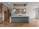 Open concept kitchen featuring a large island, hardwood floors, and stainless steel appliances at 200 Broadleaf Ln, Youngsville, NC 27596