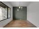 This living room boasts hardwood floors, a modern light fixture, and decorative wall paneling at 200 Broadleaf Ln, Youngsville, NC 27596