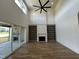 Spacious living room with a fireplace, built-in bookshelves, and sliding glass doors at 200 Broadleaf Ln, Youngsville, NC 27596