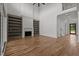 Bright open-concept living room features fireplace, custom built-ins, and hardwood floors at 200 Broadleaf Ln, Youngsville, NC 27596