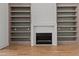 Inviting living room features a fireplace with tile surround and custom built-in shelving at 200 Broadleaf Ln, Youngsville, NC 27596