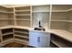 Convenient walk-in pantry with custom shelving, quartz countertops, and sink at 200 Broadleaf Ln, Youngsville, NC 27596
