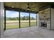 Covered patio features a stone fireplace and screens to enjoy outdoor living at 200 Broadleaf Ln, Youngsville, NC 27596