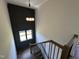 Staircase featuring neutral walls, hardwood treads, and a dark green accent wall at 200 Broadleaf Ln, Youngsville, NC 27596