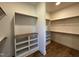 Spacious walk-in closet with custom shelving and wooden accents at 200 Broadleaf Ln, Youngsville, NC 27596