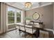 Bright dining room with a large window, a coffered ceiling, and a modern chandelier at 203 Great Smoky Pl, Lillington, NC 27546