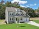 Charming two-story home with gray siding, white trim, large windows, covered porch, and three-car garage at 203 Great Smoky Pl, Lillington, NC 27546