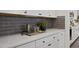 Close up of the kitchen counter space with a subway tile backsplash and under-cabinet lighting at 203 Great Smoky Pl, Lillington, NC 27546