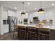 Charming kitchen with white cabinets, stainless steel appliances, and counter with barstool seating at 203 Great Smoky Pl, Lillington, NC 27546