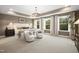 Serene main bedroom featuring a large bed, ample lighting, and three large windows with a green outdoor view at 203 Great Smoky Pl, Lillington, NC 27546