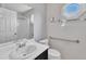 Clean bathroom with white sink, octagon window, mirror, and accessibility features at 205 Lizzie King Ct, Willow Springs, NC 27592