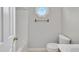 Bright bathroom featuring octagon window and towel rack above toilet at 205 Lizzie King Ct, Willow Springs, NC 27592