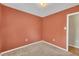 Red-walled bedroom with neutral carpeting; minimal decor at 205 Lizzie King Ct, Willow Springs, NC 27592