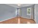 An empty bedroom featuring wood floors and two windows with natural light at 205 Lizzie King Ct, Willow Springs, NC 27592