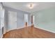 An empty bedroom with wood floors and views to the bathroom and closets at 205 Lizzie King Ct, Willow Springs, NC 27592