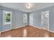 An empty bedroom featuring wood floors, 2 windows, and a door to a bathroom at 205 Lizzie King Ct, Willow Springs, NC 27592