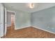 An empty bedroom with wood floors and doors to the bathroom and closets at 205 Lizzie King Ct, Willow Springs, NC 27592