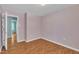 Bedroom with open door to another room; wood flooring throughout at 205 Lizzie King Ct, Willow Springs, NC 27592