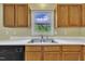 Close-up of the kitchen sink and countertop with wood cabinets above and below at 205 Lizzie King Ct, Willow Springs, NC 27592