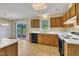 A bright kitchen with wooden cabinets, a white countertop, and a view to the outside at 205 Lizzie King Ct, Willow Springs, NC 27592