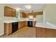 Bright kitchen showcasing wood cabinets, white countertops, and modern appliances, including a dishwasher and oven at 205 Lizzie King Ct, Willow Springs, NC 27592