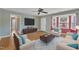 Comfortable living room featuring hardwood floors, a neutral color scheme, large screen TV, and bay windows at 205 Lizzie King Ct, Willow Springs, NC 27592