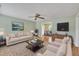 Relaxing living room featuring hardwood floors, neutral colored walls, and open access to the kitchen and dining area at 205 Lizzie King Ct, Willow Springs, NC 27592