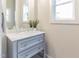 Neutral powder room with light-blue vanity and a white marble countertop at 211 Page St, Morrisville, NC 27560