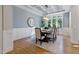 Elegant dining room with natural light, a stylish chandelier, and beautiful hardwood floors at 211 Page St, Morrisville, NC 27560