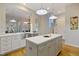 Bright modern kitchen with white cabinets, stainless steel appliances, and a center island at 211 Page St, Morrisville, NC 27560