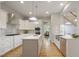 Stylish kitchen with white cabinets, stainless appliances, and hardwood flooring at 211 Page St, Morrisville, NC 27560