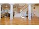 Open concept living room featuring a staircase, wood floors, and seamless flow into the living area at 211 Page St, Morrisville, NC 27560