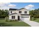 Charming two-story home with a manicured lawn, a two-car garage, and beautiful architectural detailing at 220 Sprenger St, Garner, NC 27529