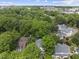 This is an aerial shot featuring a lush, tree-lined neighborhood with a mix of residential homes and cityscape views at 223 Hawthorne Rd, Raleigh, NC 27605